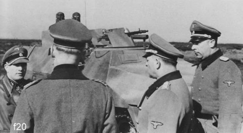 20 Sd.Kfz. 251 fitted with flame projectors from 12. SS Panzer Division Hitlerjugend being inspected by officers at the Beverloo Training Ground.jpg