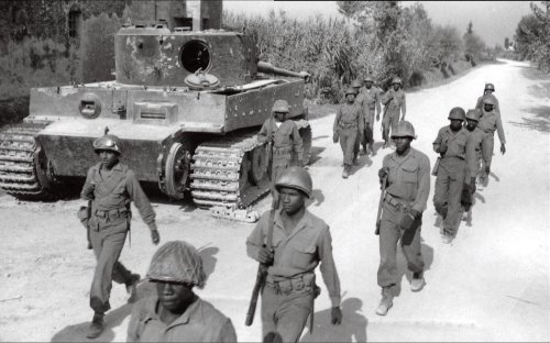 US soldiers walk past an abandoned Tiger I tank that was undergoing maintenance in Italy, 1944.jpg