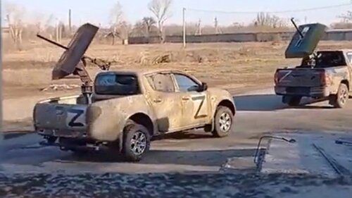 Convoy-of-ISIS-style-Toyota-and-Mitsubishi-pickup-trucks-used-by-the-Russian-military-in-Ukraine-driving-on-a-street.jpg